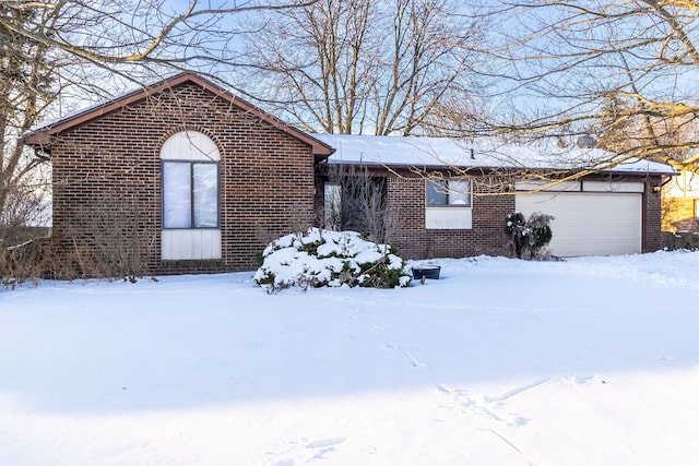 ranch-style home with brick siding and an attached garage