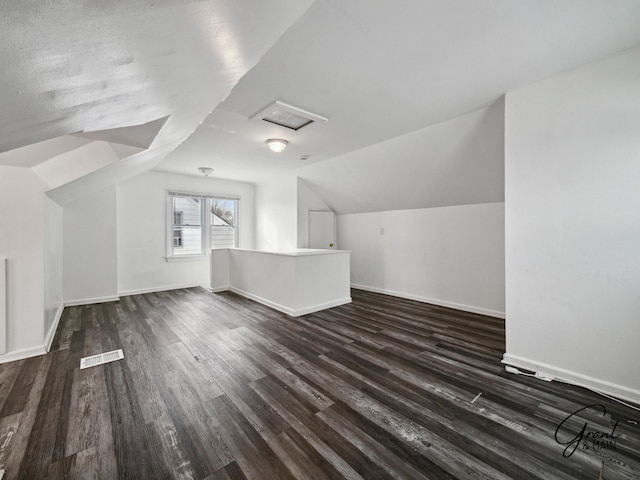 9941 Minock St, Detroit, MI 48228 - additional living space featuring vaulted ceiling and dark hardwood / wood-style flooring