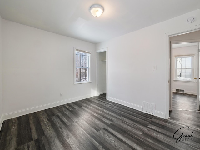 9941 Minock St, Detroit, MI 48228 - empty room with dark wood-type flooring and a wealth of natural light