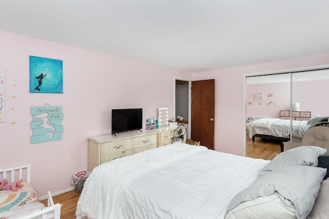 bedroom featuring a closet and light hardwood / wood-style floors