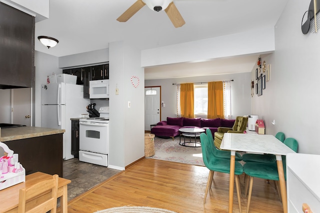 kitchen with white appliances, ceiling fan, and hardwood / wood-style floors