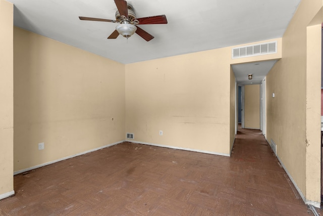 spare room featuring parquet floors and ceiling fan