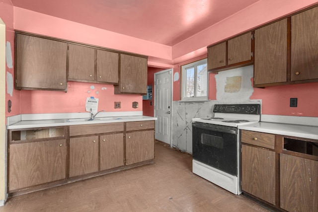 kitchen featuring sink and white electric range oven