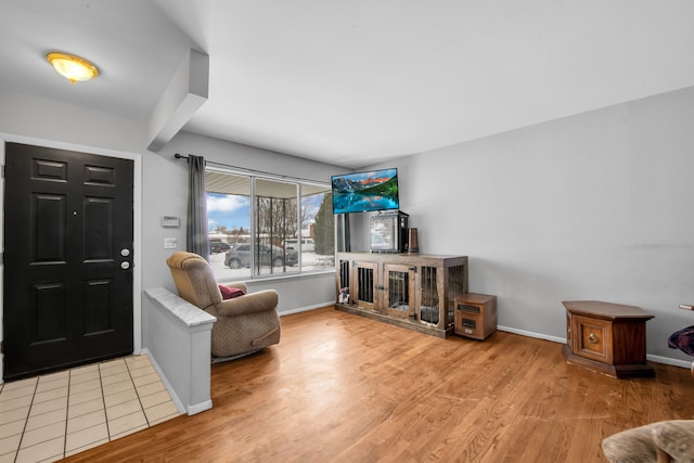 foyer featuring light wood-style flooring and baseboards