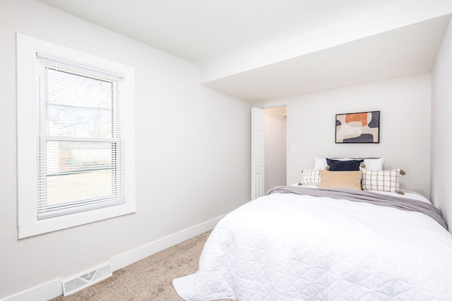 bedroom with carpet floors, visible vents, and baseboards