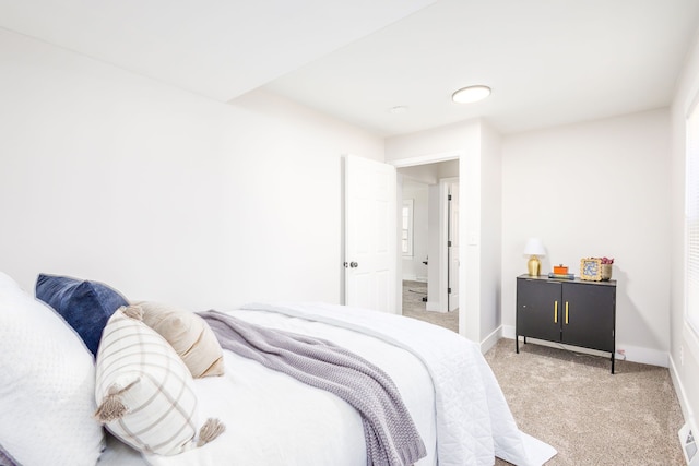 bedroom featuring light colored carpet and baseboards