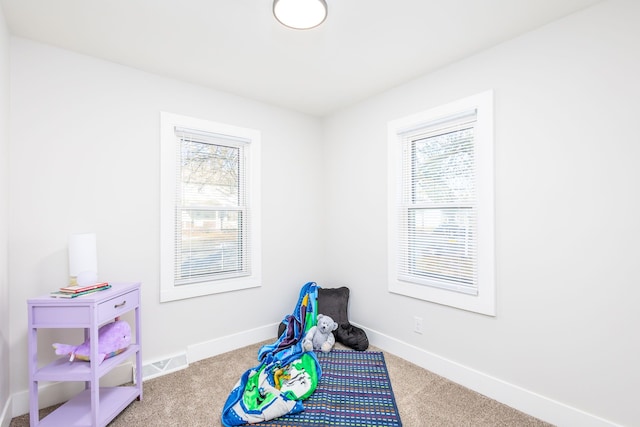 recreation room featuring carpet flooring, visible vents, and baseboards