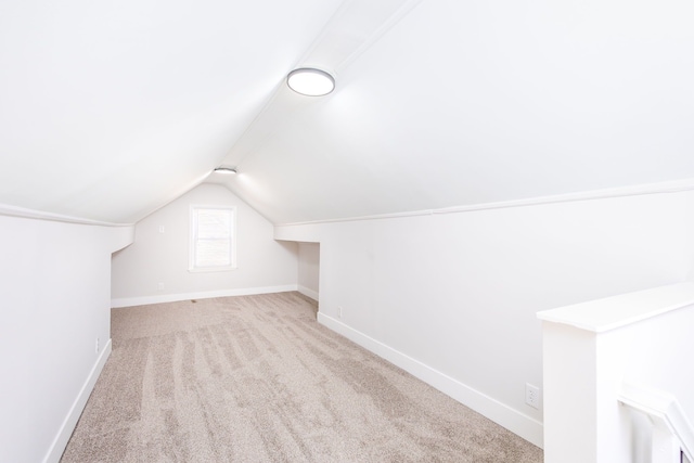 bonus room featuring vaulted ceiling, carpet flooring, and baseboards