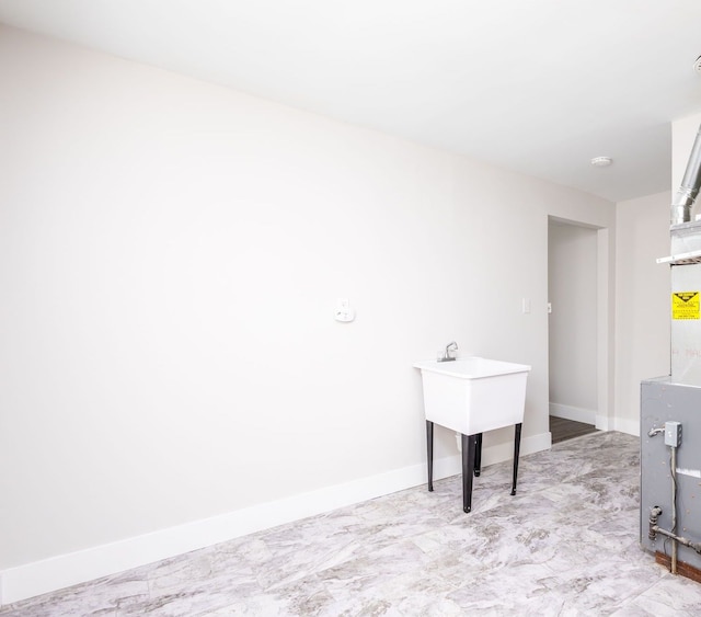 laundry room featuring baseboards