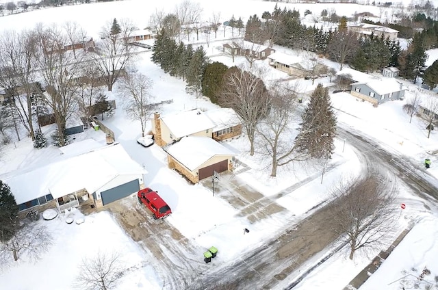 snowy aerial view featuring a residential view