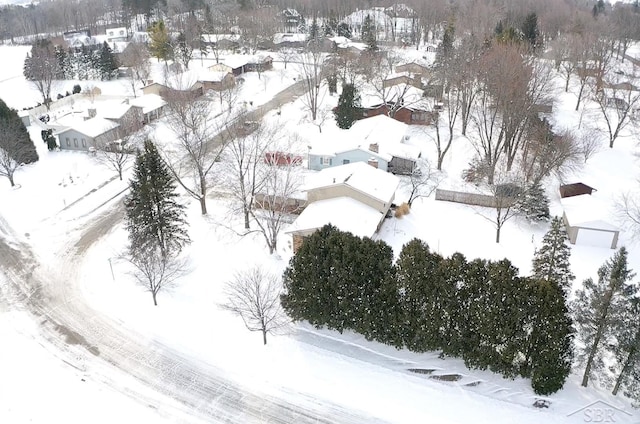 snowy aerial view with a residential view