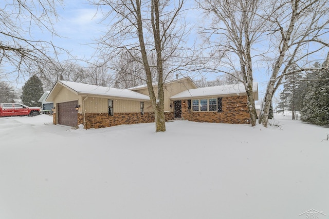 ranch-style home featuring an outbuilding, brick siding, and a garage