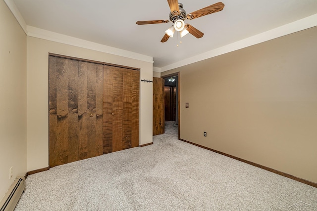 unfurnished bedroom with crown molding, carpet flooring, baseboards, and baseboard heating