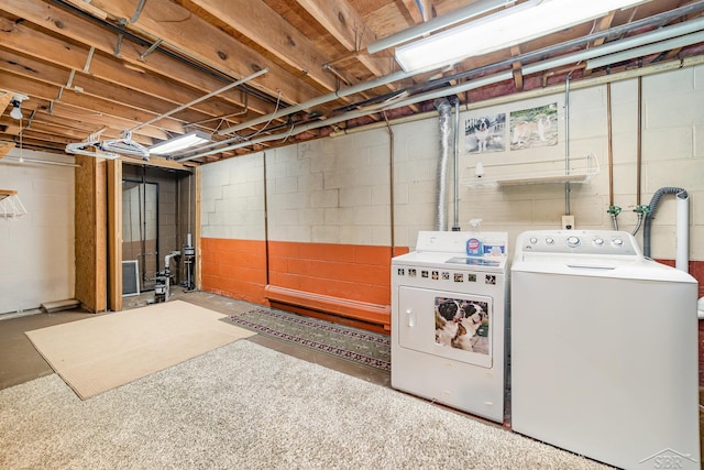 unfinished basement featuring washing machine and clothes dryer