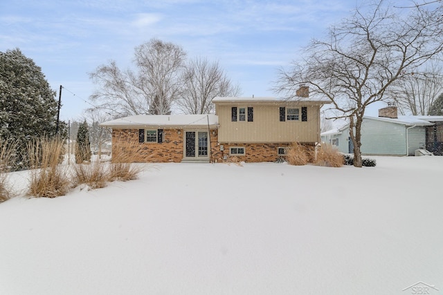 view of front of house featuring a chimney and a garage