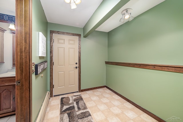 entryway with light floors, baseboards, and baseboard heating