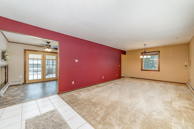 tiled spare room with a wealth of natural light, french doors, and a textured ceiling