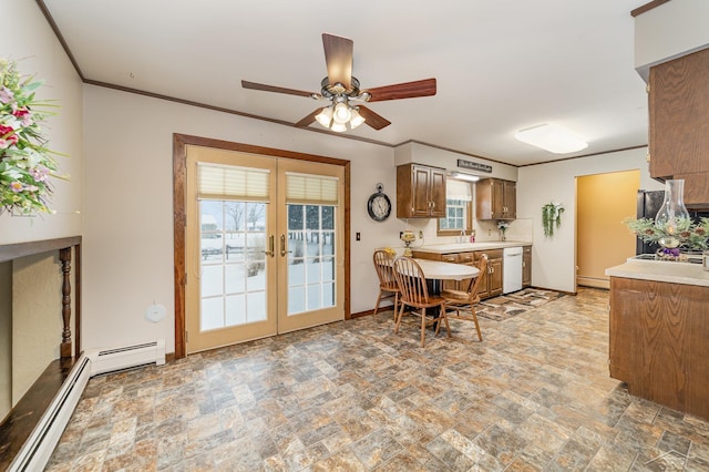 dining area featuring ornamental molding, french doors, baseboards, and stone finish flooring