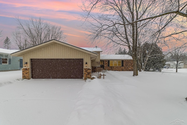 view of front facade with brick siding and an attached garage