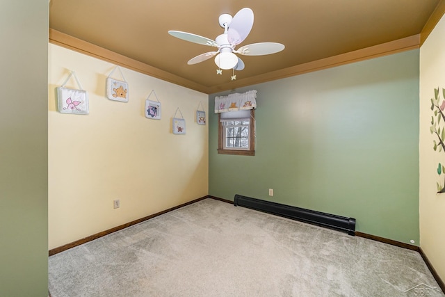 carpeted spare room featuring a ceiling fan, baseboards, baseboard heating, and ornamental molding