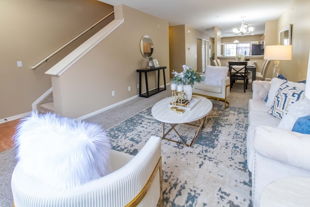 living room featuring carpet flooring and a chandelier