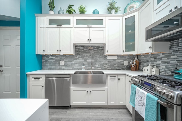 kitchen featuring sink, white cabinets, and appliances with stainless steel finishes