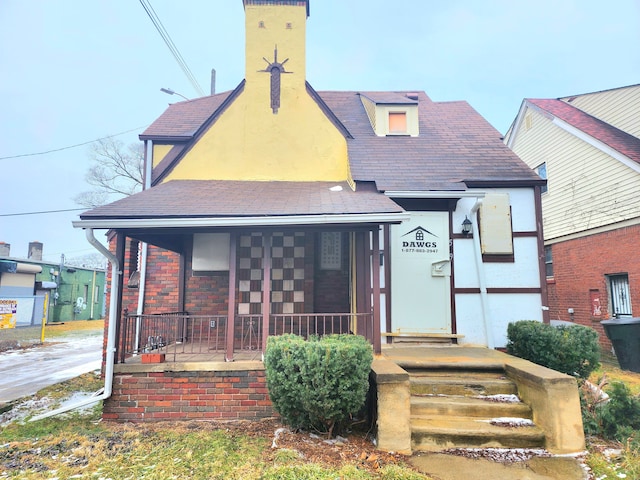 view of front facade with a porch and stucco siding