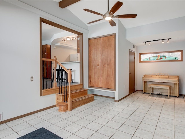 tiled spare room featuring vaulted ceiling with beams, rail lighting, and ceiling fan