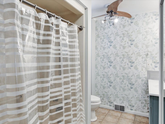 bathroom featuring tile patterned flooring, a shower with curtain, toilet, ceiling fan, and vanity