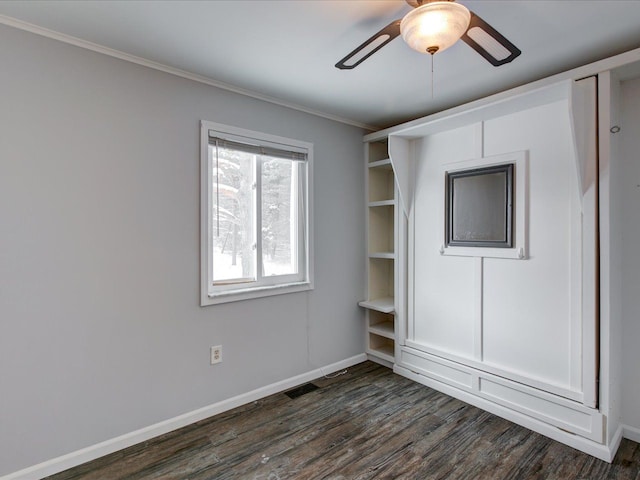 unfurnished bedroom featuring ornamental molding, dark hardwood / wood-style floors, and ceiling fan