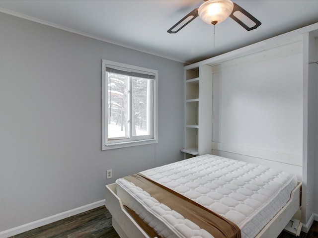 bedroom with crown molding, dark hardwood / wood-style floors, and ceiling fan