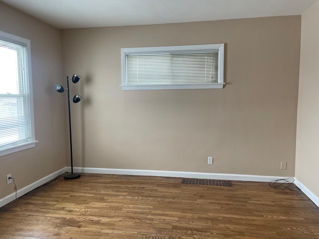 unfurnished room with hardwood / wood-style flooring