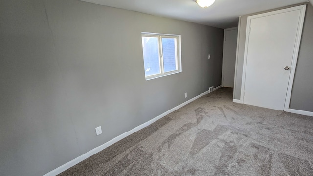 unfurnished bedroom featuring carpet and baseboards