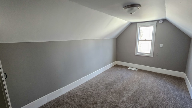 bonus room featuring carpet, baseboards, visible vents, and vaulted ceiling