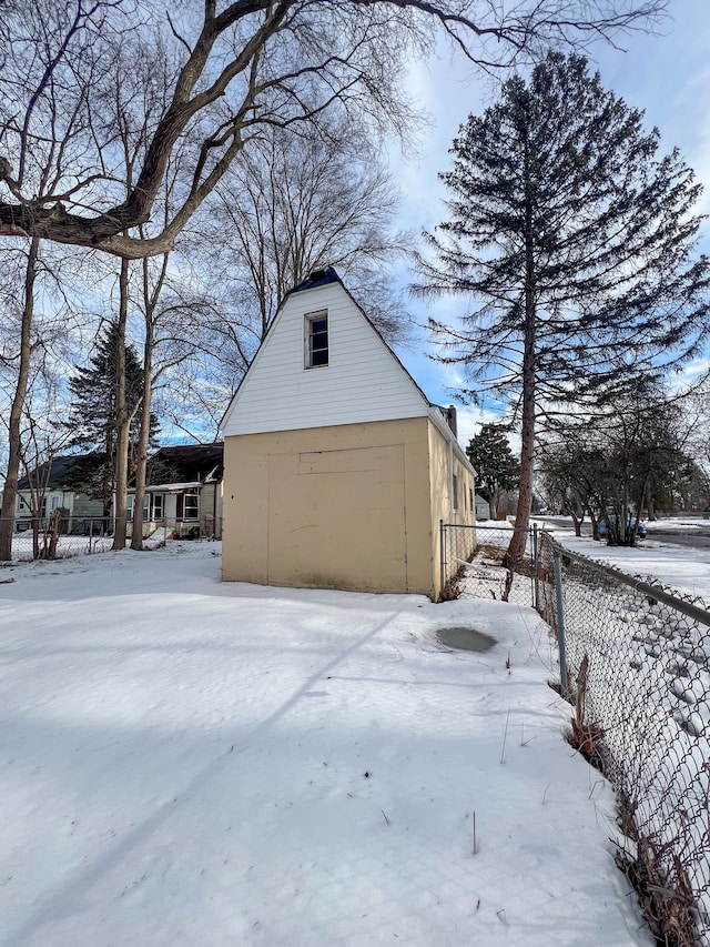 exterior space with a detached garage and fence