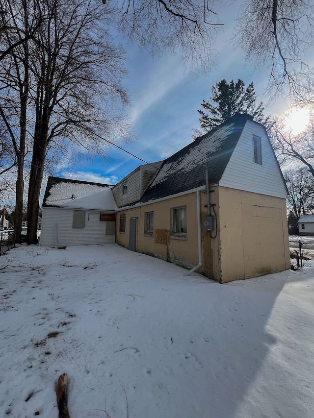 snow covered property featuring a garage