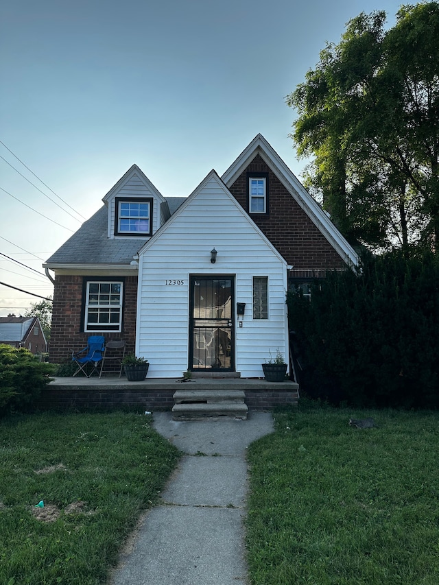 bungalow-style house with a patio and a front lawn