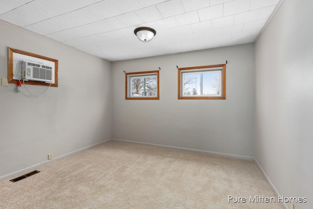 carpeted empty room with an AC wall unit