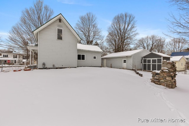 view of snow covered rear of property