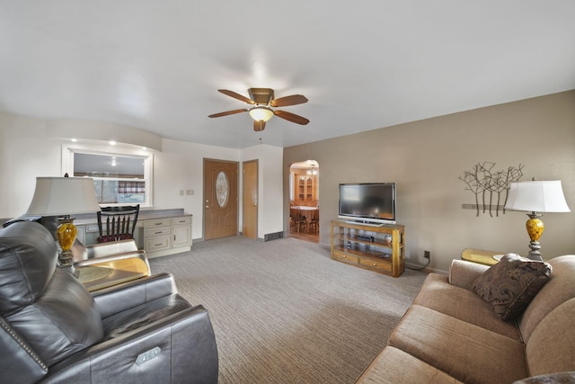 living room with ceiling fan and light colored carpet