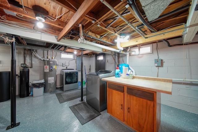 basement featuring water heater and separate washer and dryer