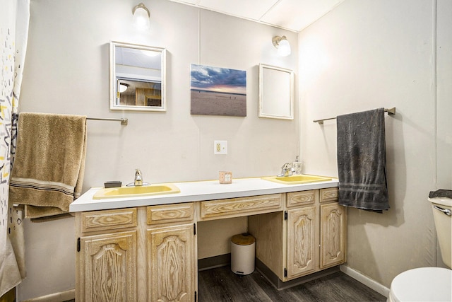 bathroom featuring vanity, hardwood / wood-style floors, and toilet