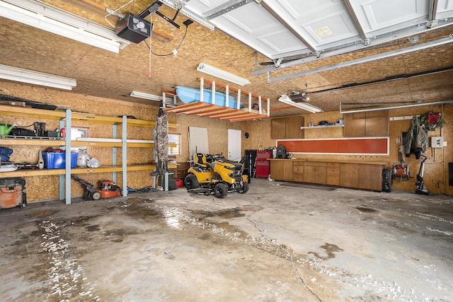 garage with a garage door opener and a workshop area