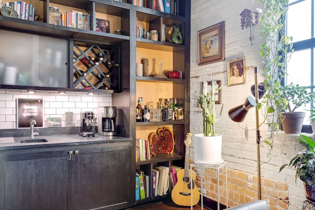 bar featuring tasteful backsplash and brick wall