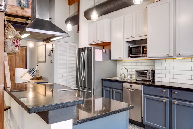 kitchen with stainless steel appliances, white cabinetry, blue cabinetry, island exhaust hood, and pendant lighting