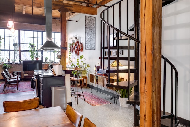 interior space featuring stairs, baseboards, and speckled floor