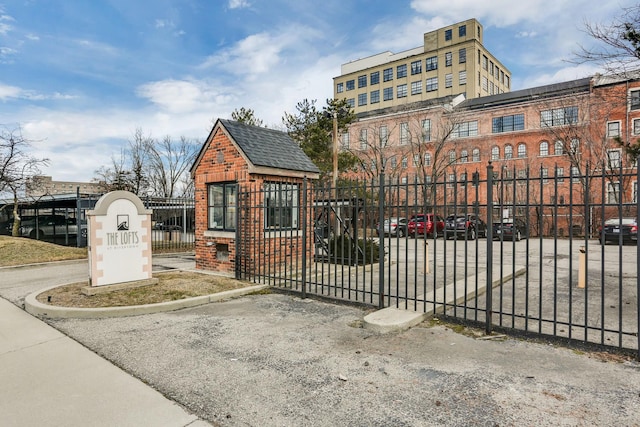 view of gate with a fenced front yard