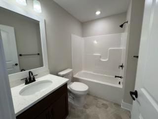 bathroom featuring toilet, vanity, and  shower combination