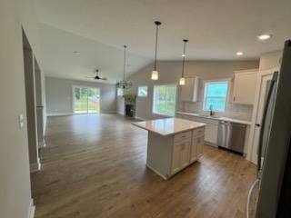 kitchen featuring ceiling fan, open floor plan, plenty of natural light, wood finished floors, and recessed lighting