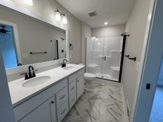 full bath with marble look tiles, a stall shower, toilet, double vanity, and recessed lighting